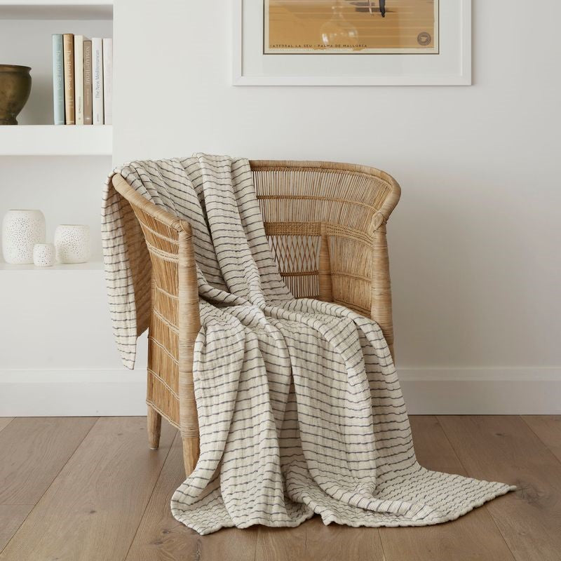 Lightweight Ecru and Charcoal striped throw blanket, 130 x 170 cm, made from soft cotton gauze, perfect for cozy lounging.
