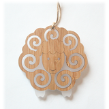 White sheep ornament made of sustainable bamboo and satin acrylic, perfect for holiday decor and gifting.