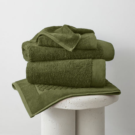 Eco-friendly bamboo bath mat in moss green, soft and absorbent, measuring 51 x 76cm, ideal for sensitive skin.