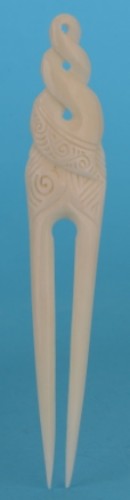Handcrafted Kiwiana Heru comb featuring a triple twist design, symbolizing connection and unity in vibrant colors.
