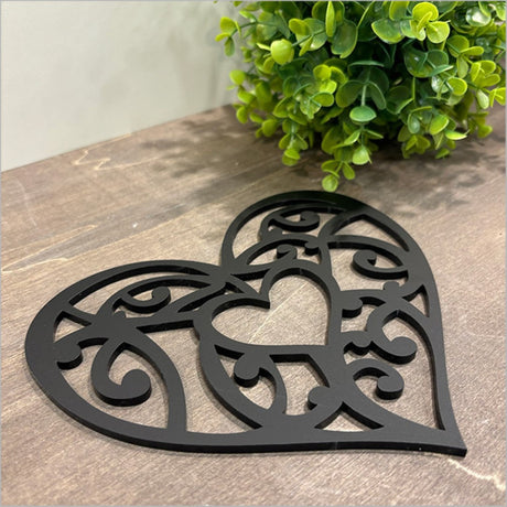 Black acrylic heart wall art featuring traditional Kowhaiwhai patterns, perfect for modern home decor.