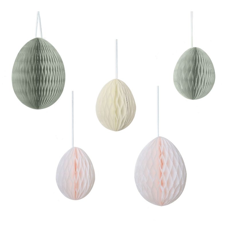 Colorful honeycomb egg decorations for Easter, featuring cream, light pink, and sage green, perfect for festive hanging.