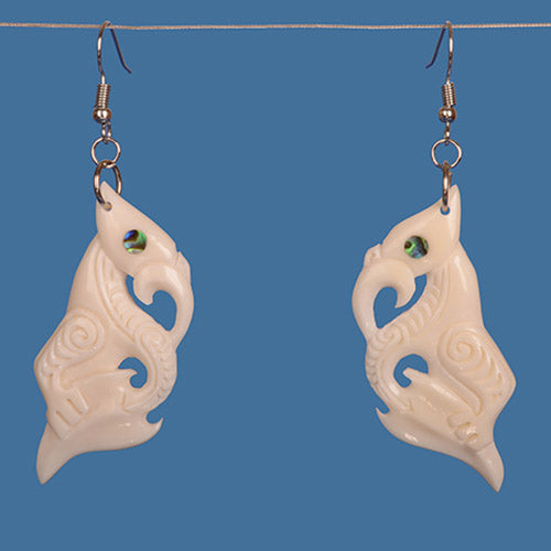 Handcrafted Manaia Bone Earring featuring intricate Maori design and vibrant paua shell accents, symbolizing protection.