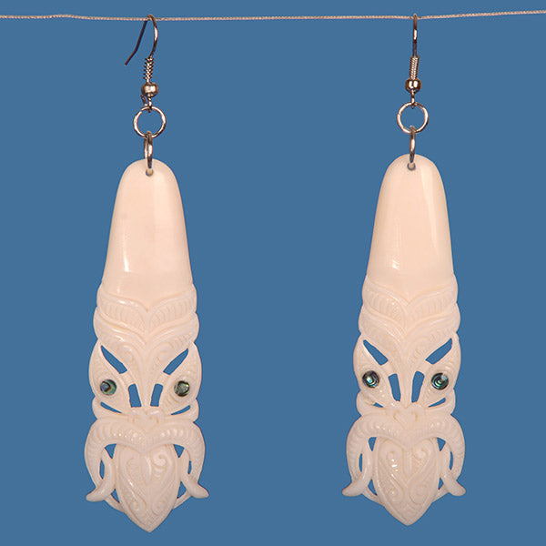 Handcrafted Bone Toki Earrings featuring vibrant paua shell accents, celebrating M?ori artistry and culture.