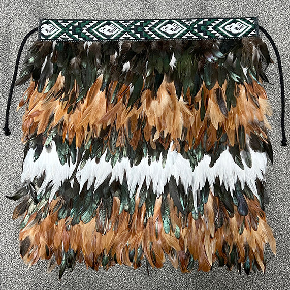 Korowai Tamariki - Ruru: Handmade, vibrant, feathered garment inspired by M?ori culture, perfect for special occasions.