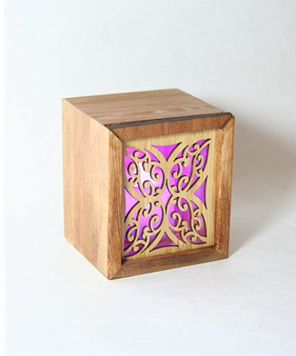 LED tealight candle box in laser-cut bamboo with Kowhaiwhai design, features color-changing LED for elegant ambiance.