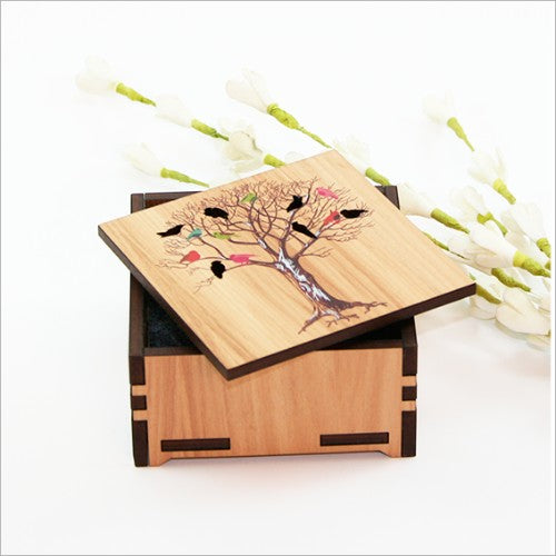 Small wooden trinket box with a birds on tree design and paua inlay, perfect for storing jewelry and keepsakes.