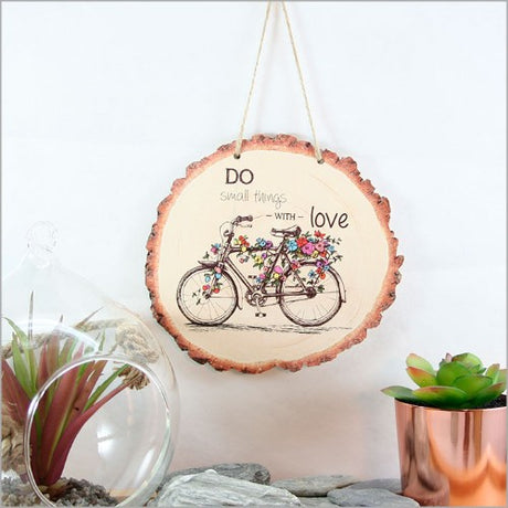 Rustic wood slice wall art featuring a detailed bicycle design, perfect for bike enthusiasts and nature lovers.