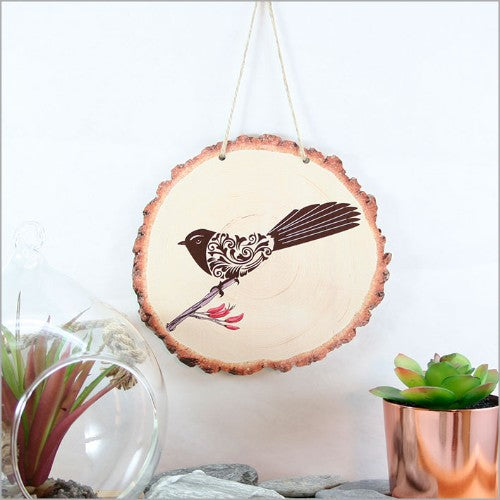 Rustic wood slice wall art featuring an elegant filigree fantail design, ready to hang, perfect for enhancing any space.