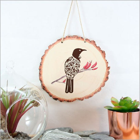 Intricately designed wood slice wall art featuring a Tui, blending modern artistry with nature-inspired craftsmanship.