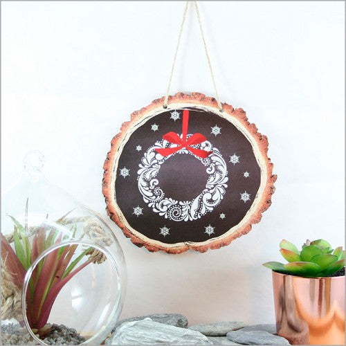 Intricate wood slice wall art featuring a filigree wreath design on durable veneer, ideal for rustic and contemporary decor.