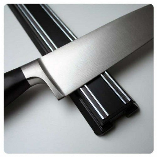 Sleek black 450mm magnetic knife rack securely organizes kitchen knives, enhancing kitchen decor and efficiency.