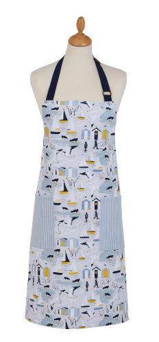 Stylish cotton apron featuring seaside design with fishermen silhouettes, adjustable straps, and practical pocket.