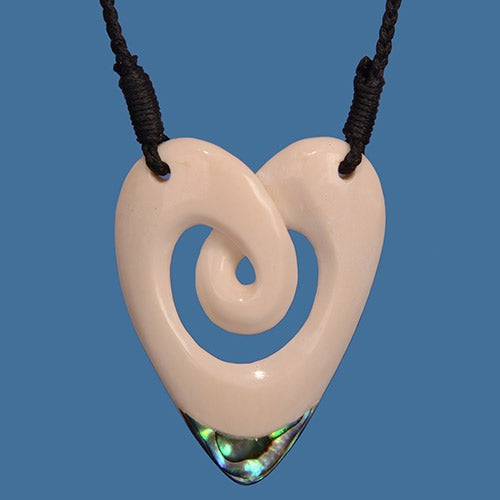 Large heart pendant necklace with twist design and vibrant P?ua shell inlay on adjustable wax cord.