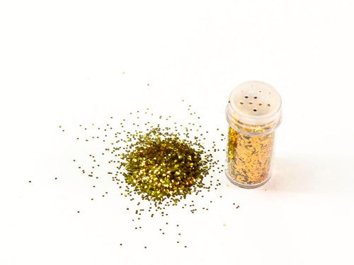 Ultra-fine gold glitter in 10gm package, perfect for scrapbooking and DIY crafts.