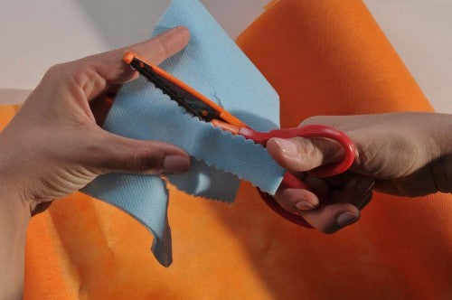 Vibrant orange Smart-Fab roll, versatile non-woven fabric for crafting, cutting, and decorating projects.