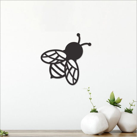 Stylish black acrylic bee wall art, measuring 11.5cm, perfect for modern decor and easy to mount on any wall.