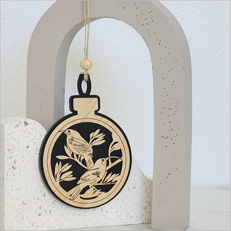 Black satin acrylic hanging ornament featuring a unique huia design, perfect for holiday decor and gifting.