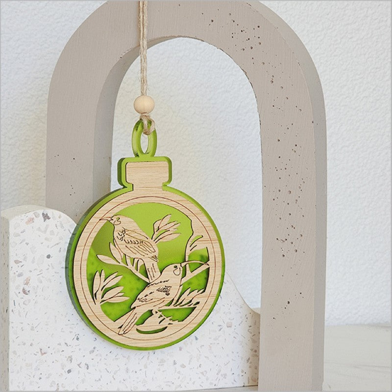 Lime satin acrylic hanging ornament featuring a Huia motif, perfect for holiday decor and gifting.
