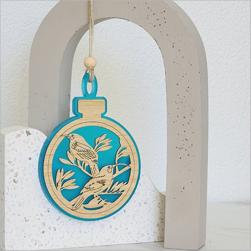 Teal satin acrylic hanging ornament shaped like a Huia, made from laser-cut bamboo, perfect for festive decor.