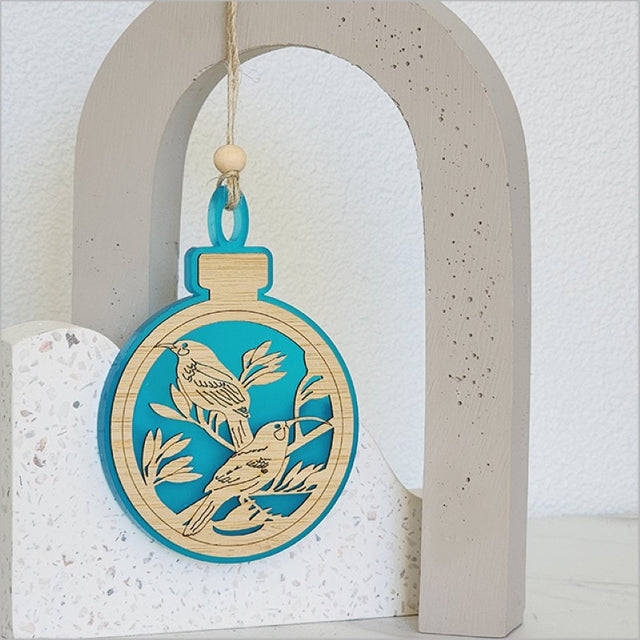 Teal satin acrylic hanging ornament shaped like a Huia, made from laser-cut bamboo, perfect for festive decor.