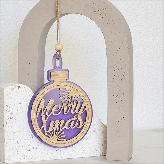 Purple satin acrylic bauble ornament featuring a laser-cut 'Merry Xmas' design, perfect for festive decor.