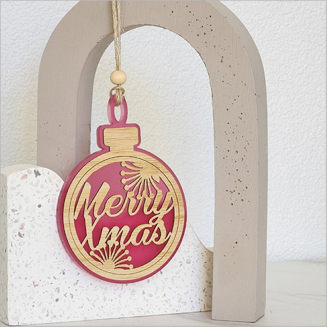 Pink satin acrylic hanging ornament with laser-cut bamboo base, perfect for festive decor and gift giving.