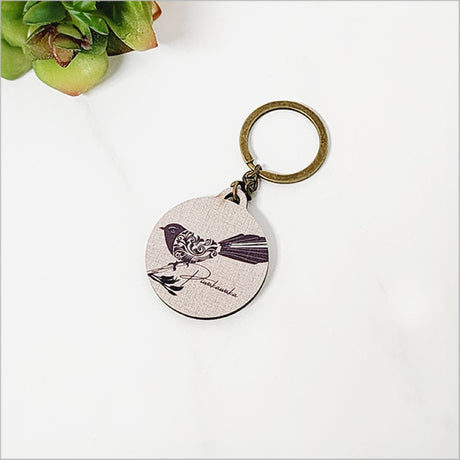 Lightweight printed pine keychain featuring an intricate filigree design inspired by New Zealand's Fantail bird.