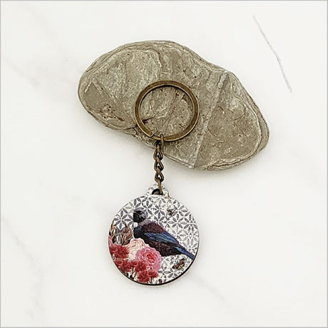 Floral Tui keychain, lightweight pine veneer, 40mm diameter, celebrating New Zealand wildlife and Kiwiana style.
