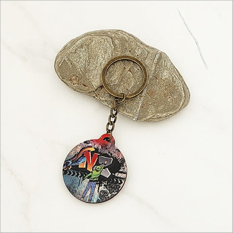 Unique printed pine veneer keychain featuring Kiwiana design, lightweight, 40mm diameter, ideal for gifts and travel.
