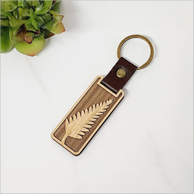 Eco-friendly bamboo keyring featuring fern design, lightweight and stylish for key organization.