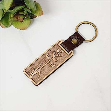 Lightweight bamboo keyring with Kiwiana design, perfect for eco-friendly style and travel gifts.