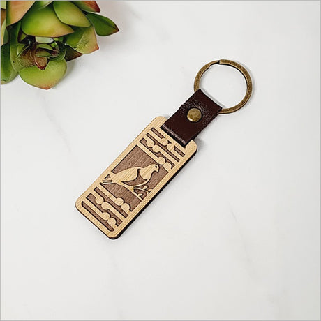 Eco-friendly bamboo keyring featuring Kereru and Koru designs, perfect for Kiwiana charm and everyday use.