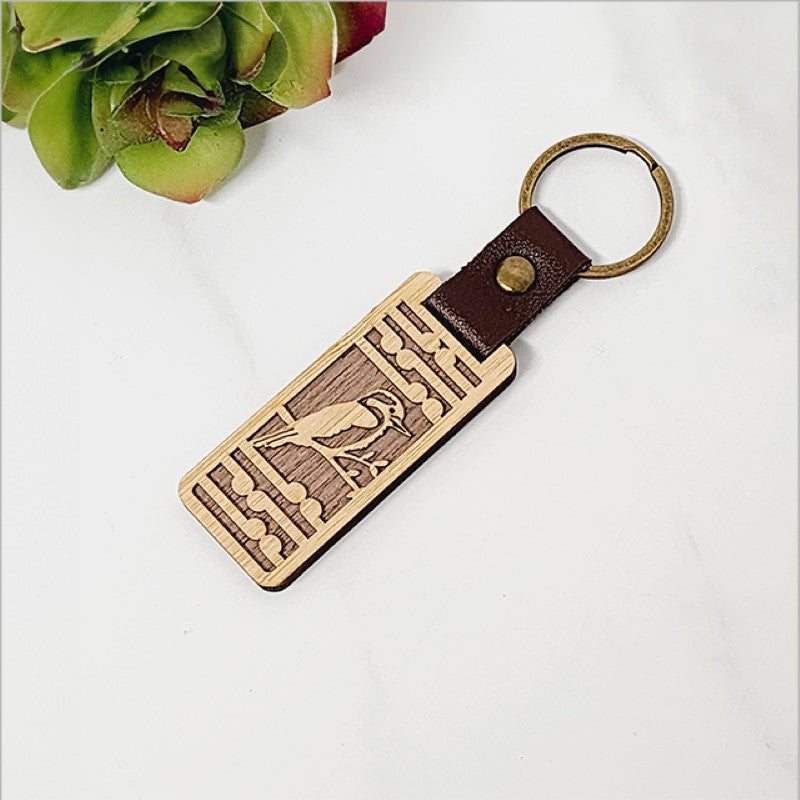 Lightweight bamboo keyring with Kingfisher design and Koru pattern, perfect for eco-friendly style and Kiwiana charm.