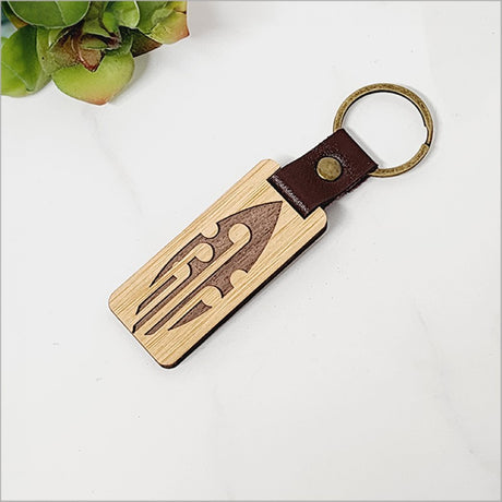 Eco-friendly bamboo keyring with Kiwiana design, lightweight, and stylish, perfect for keys or souvenirs.