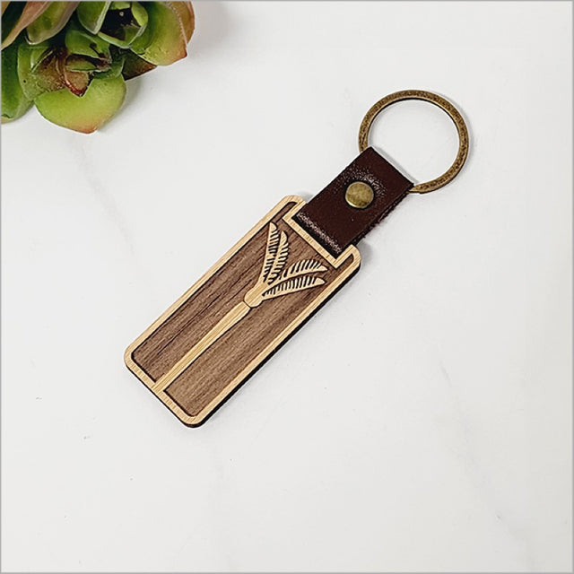 Sustainable bamboo keyring featuring intricate laser-cut patterns, 110mm long, adds Kiwiana charm to your keys.