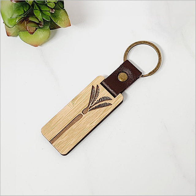 Eco-friendly Bamboo Keyring featuring intricate Nikau palm design, perfect for stylish and sustainable key organization.