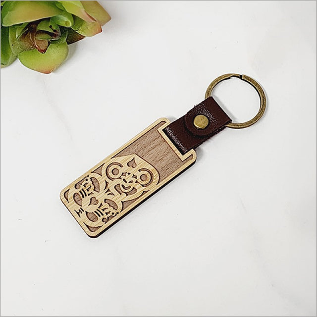 Eco-friendly bamboo keyring in Tiki design, measuring 28mm x 64mm, perfect for adding Kiwiana charm to keys.