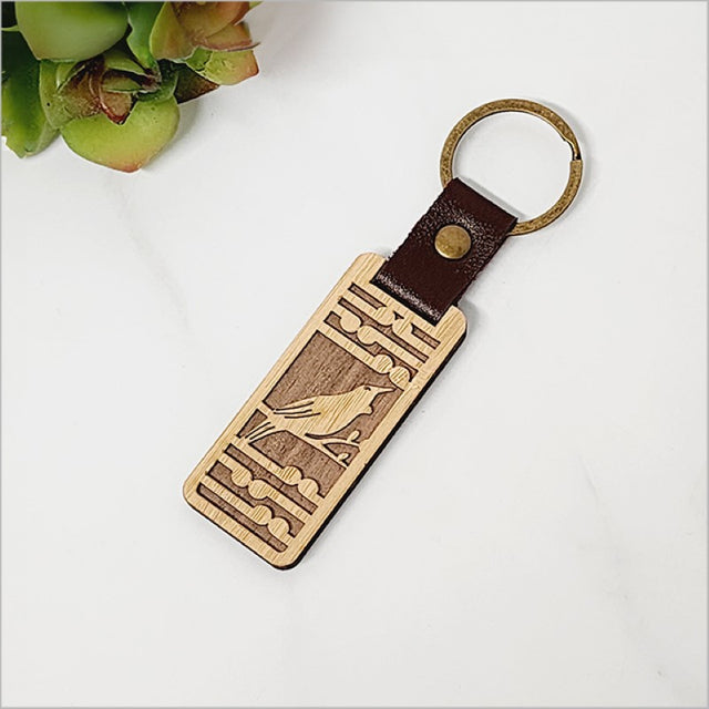 Lightweight bamboo keyring featuring Tui bird and Koru design, perfect for everyday use and eco-friendly gifting.