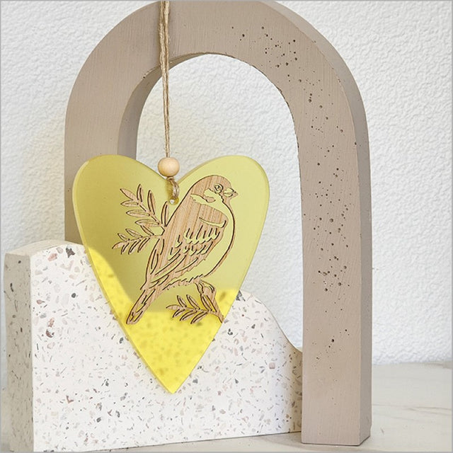 Yellow satin acrylic heart ornament featuring intricate nature designs, perfect for home decor or gifts.