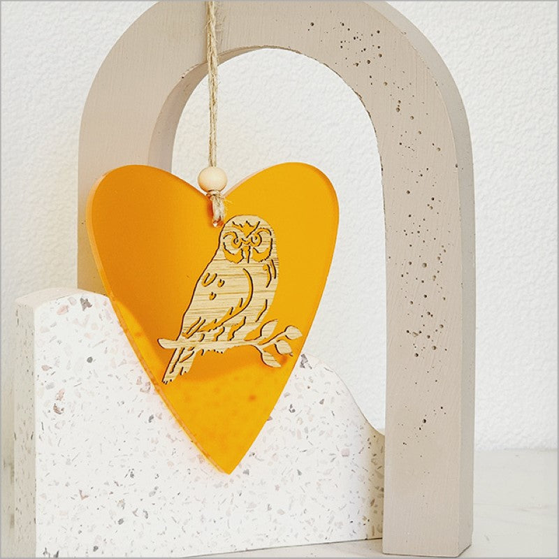 Vibrant orange heart-shaped hanging ornament with laser-cut bamboo and satin acrylic, perfect for holiday decor and gifting.