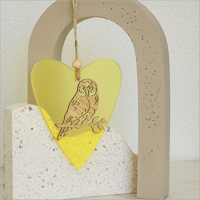 Yellow satin acrylic heart ornament with laser-cut bamboo design, perfect for festive decor and gifting.