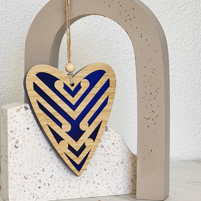 Heart-shaped blue satin acrylic hanging ornament featuring intricate Koru designs, symbolizing new beginnings.