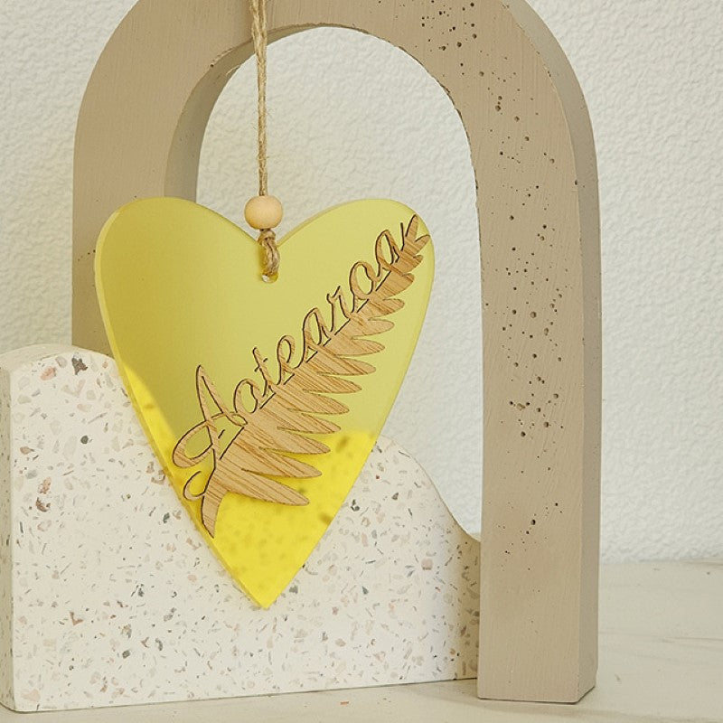Yellow satin acrylic heart ornament with laser-cut bamboo, ready to hang, measuring 90mm x 105mm x 8mm thick.