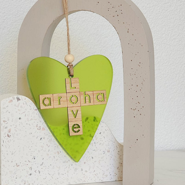 Vibrant lime satin acrylic heart ornament embodying love, measuring 110mm x 78mm, perfect for home decor and gifting.