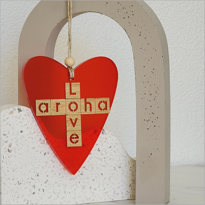 Red satin acrylic heart ornament with 'Aroha + Love' design, perfect for home decor and thoughtful gifting.