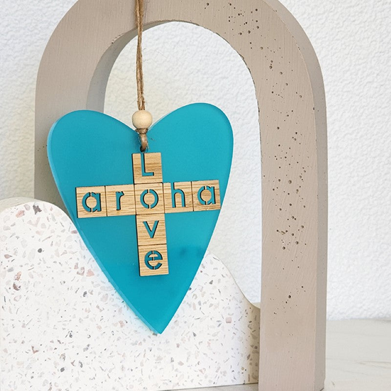 Teal satin acrylic heart ornament with laser-cut bamboo, symbolizing Aroha (love) and perfect for holiday decor.
