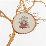 Wood slice wall art featuring Sarah Featon's watercolor K ?k ?beak floral illustration, perfect for nature-inspired decor.