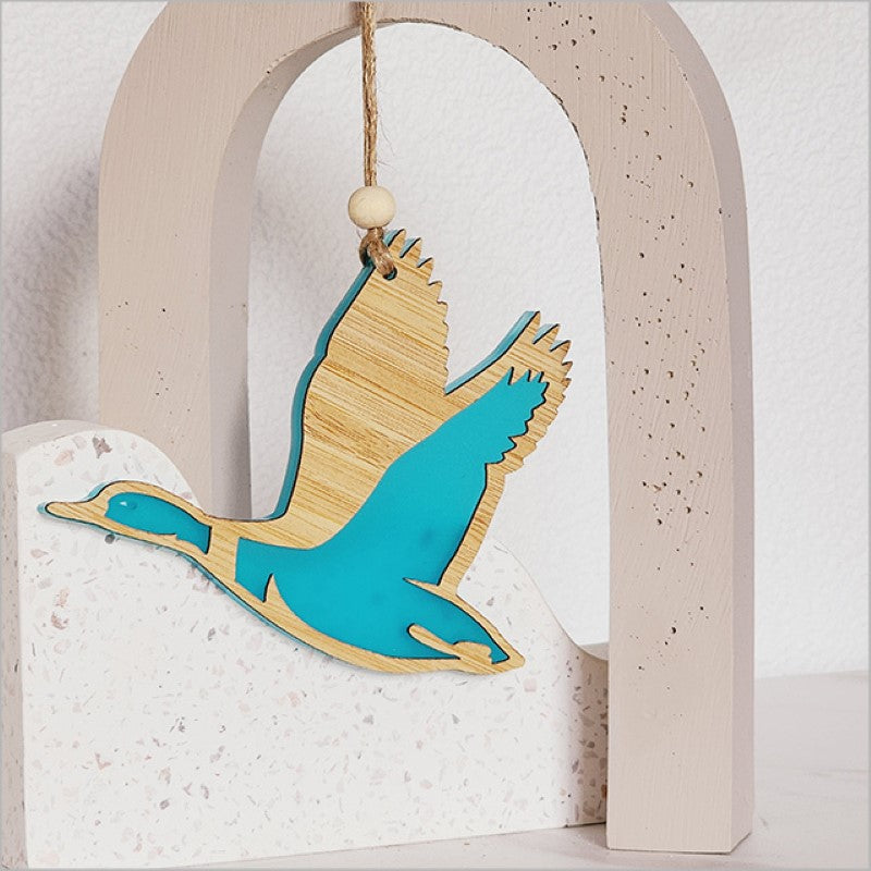 Teal satin acrylic duck ornament featuring intricate laser-cut designs, perfect for unique home decor.