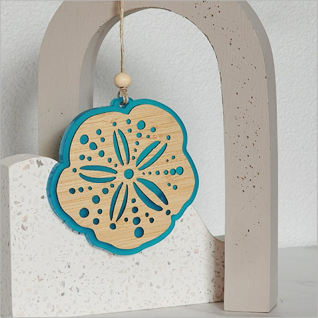 Teal satin acrylic hanging ornament with intricate laser-cut bamboo design, perfect for home decor or gifts.